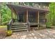 Charming front porch with dark wooden railings and stairs, perfect for relaxing outdoors at 6412 Heartwood Dr, Chapel Hill, NC 27516