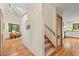 Entry hallway with staircase, connecting the living area and kitchen, with natural light at 6412 Heartwood Dr, Chapel Hill, NC 27516