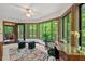Bright home office with multiple windows, a ceiling fan, and a door that leads to the porch at 6412 Heartwood Dr, Chapel Hill, NC 27516