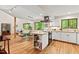 Bright, open-concept kitchen with modern appliances and large windows overlooking the wooded landscape at 6412 Heartwood Dr, Chapel Hill, NC 27516