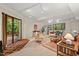 Cozy living room features track lighting, stylish furnishings, and a sliding glass door to the outside at 6412 Heartwood Dr, Chapel Hill, NC 27516