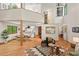 Spacious living room showcasing natural light, hardwood floors, open layout to the kitchen and unique architectural details at 6412 Heartwood Dr, Chapel Hill, NC 27516