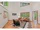 Bright living room featuring high ceilings, stylish furnishings, and large windows for ample natural light at 6412 Heartwood Dr, Chapel Hill, NC 27516