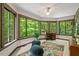 Bright office featuring large windows offering natural views, comfortable seating, and ample desk space at 6412 Heartwood Dr, Chapel Hill, NC 27516