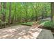 Exterior parking area adjacent to the wooded lot at 6412 Heartwood Dr, Chapel Hill, NC 27516