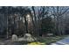 Picturesque horses grazing in a tranquil, wooded pasture near the Heartwood community sign at 6412 Heartwood Dr, Chapel Hill, NC 27516