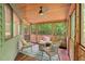 Cozy screened porch with comfortable seating, natural light, and a peaceful outdoor retreat at 6412 Heartwood Dr, Chapel Hill, NC 27516