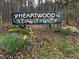 Welcome to Heartwood sign surrounded by spring daffodils at 6412 Heartwood Dr, Chapel Hill, NC 27516