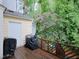 Wood back deck with grilling equipment overlooks green wooded backyard at 6756 Olde Province Ct, Raleigh, NC 27609