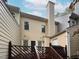 Backyard view from an elevated deck with wood railing and grilling equipment at 6756 Olde Province Ct, Raleigh, NC 27609