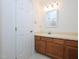 Comfortable bathroom with a cream sink with wood cabinets at 6756 Olde Province Ct, Raleigh, NC 27609