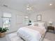 Bedroom with new furniture and decor that includes a fan, plant, and two windows at 6756 Olde Province Ct, Raleigh, NC 27609