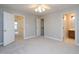 Bedroom with carpet, neutral walls, and multiple doorways at 6756 Olde Province Ct, Raleigh, NC 27609