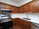 Kitchen features stainless steel microwave, range, cabinets, backsplash, and countertops at 6756 Olde Province Ct, Raleigh, NC 27609