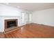 Spacious living room features a fireplace, hardwood floors, and back patio door at 6756 Olde Province Ct, Raleigh, NC 27609
