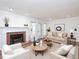 Bright living room with fireplace, neutral furniture, and French doors to backyard at 6756 Olde Province Ct, Raleigh, NC 27609