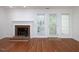 Living room featuring a brick fireplace and access to the outside at 6756 Olde Province Ct, Raleigh, NC 27609