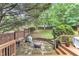 Stone patio with a fire pit and lush greenery, perfect for enjoying outdoor evenings in a private backyard at 6828 Edwell Ct, Raleigh, NC 27617