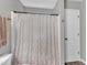 The bathroom features a tiled shower/tub with a white shower curtain and neutral-colored walls at 6828 Edwell Ct, Raleigh, NC 27617