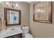 Cozy bathroom with a decorative mirror, artwork, vanity, and essential fixtures, offering functionality and style at 6828 Edwell Ct, Raleigh, NC 27617