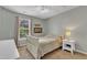 Bedroom features light-colored walls, carpeted floors, a ceiling fan and a large window at 6828 Edwell Ct, Raleigh, NC 27617