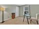 Bedroom/office space featuring a modern glass desk, neutral walls, and carpeting at 6828 Edwell Ct, Raleigh, NC 27617