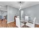 Dining area boasts hardwood floors, modern lighting, a glass table set, and stylish wall decor at 6828 Edwell Ct, Raleigh, NC 27617