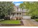 Charming two-story home with a welcoming front porch, brick accents, attached garage, and well-manicured landscaping at 6828 Edwell Ct, Raleigh, NC 27617