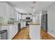 Well-lit kitchen with white cabinetry, stainless steel appliances, and a butcher block island at 6828 Edwell Ct, Raleigh, NC 27617