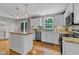 Well-appointed kitchen featuring white cabinets, stainless appliances, and easy access to the backyard at 6828 Edwell Ct, Raleigh, NC 27617