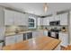 Modern kitchen with white cabinetry, granite countertops, stainless steel appliances, and stylish pendant lighting at 6828 Edwell Ct, Raleigh, NC 27617