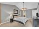 Main bedroom features a vaulted ceiling, ceiling fan, plush carpeting, natural light and ensuite bathroom at 6828 Edwell Ct, Raleigh, NC 27617