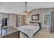 Vaulted ceiling main bedroom with a ceiling fan, carpet, neutral colors and natural light from large windows at 6828 Edwell Ct, Raleigh, NC 27617