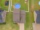 Aerial view of home showcasing the roof, driveway, and fenced backyard with in-ground pool at 71 Sandy Farm Ct, Willow Springs, NC 27592