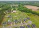 Aerial view of the neighborhood, showcasing the house, surrounding homes, and expansive green spaces at 71 Sandy Farm Ct, Willow Springs, NC 27592
