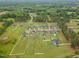 Scenic aerial view of homes nestled in a green neighborhood with mature trees and well manicured lots at 71 Sandy Farm Ct, Willow Springs, NC 27592