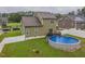 Spacious backyard featuring a well-maintained lawn, privacy fence, and above-ground swimming pool at 71 Sandy Farm Ct, Willow Springs, NC 27592
