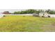 Spacious backyard featuring a small shed, metal structure, and an empty outdoor fire pit at 71 Sandy Farm Ct, Willow Springs, NC 27592