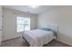 Cozy bedroom with plush carpeting, a comfortable bed, and a window offering natural light at 71 Sandy Farm Ct, Willow Springs, NC 27592