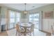 Bright dining area with a modern chandelier and a view of the backyard deck at 71 Sandy Farm Ct, Willow Springs, NC 27592