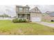 Charming two-story home featuring a welcoming front porch and attached two-car garage at 71 Sandy Farm Ct, Willow Springs, NC 27592