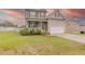 Alluring two-story home showcasing a manicured lawn, welcoming front porch, and a convenient two-car garage at 71 Sandy Farm Ct, Willow Springs, NC 27592