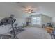Bright and airy upper-level gym with a variety of exercise machines and ample natural light at 71 Sandy Farm Ct, Willow Springs, NC 27592