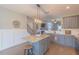 Kitchen features granite counters, seating at the island, and wainscoting and hardwood floors at 71 Sandy Farm Ct, Willow Springs, NC 27592