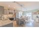 Modern kitchen with stainless steel appliances, granite countertops, island with seating, and adjacent dining area at 71 Sandy Farm Ct, Willow Springs, NC 27592