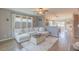 Bright living room featuring hardwood floors, ample natural light, and stylish, neutral-toned furniture at 71 Sandy Farm Ct, Willow Springs, NC 27592