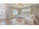 Comfortable living room with hardwood floors, large windows, neutral decor, and an open layout at 71 Sandy Farm Ct, Willow Springs, NC 27592