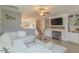 Cozy living room with a fireplace, built-in shelving, hardwood floors, and an open-concept design at 71 Sandy Farm Ct, Willow Springs, NC 27592