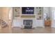 Inviting living room showcasing built-in shelving, hardwood floors, fireplace, and a staircase at 71 Sandy Farm Ct, Willow Springs, NC 27592