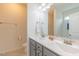 Main bathroom has double sinks, grey cabinets, and a large mirror at 71 Sandy Farm Ct, Willow Springs, NC 27592